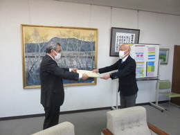写真：教育長より三浦和仁先生へ表彰状が渡される様子